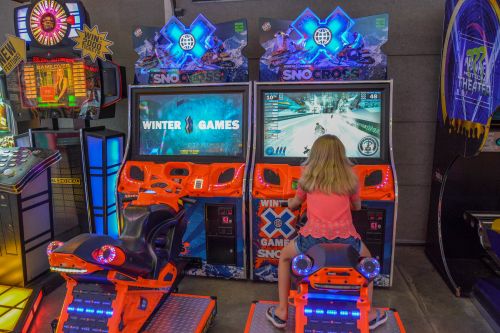 Girl Plays Arcade Games at Deep Creek Funland